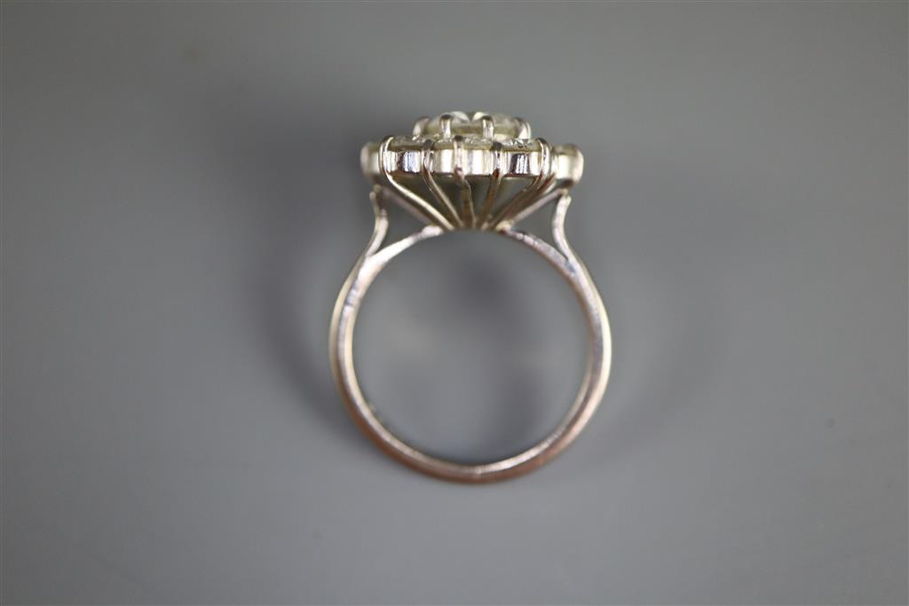 A 1970s 18ct white gold and nine stone diamond cluster ring,